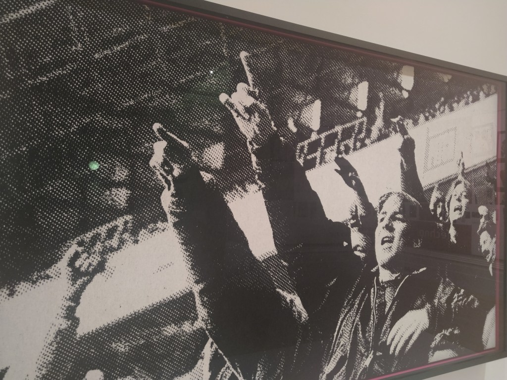 Image of the 'Who Are Ya' tapestry by Jamie Holman. It is a black and white football crowd scene. 